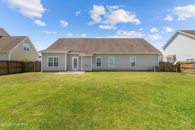 rear view of property featuring a fenced backyard, a patio, a yard, and central AC