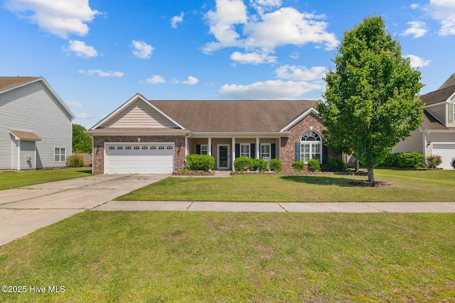 single story home featuring brick siding, a garage, a front yard, concrete driveway, and covered porch