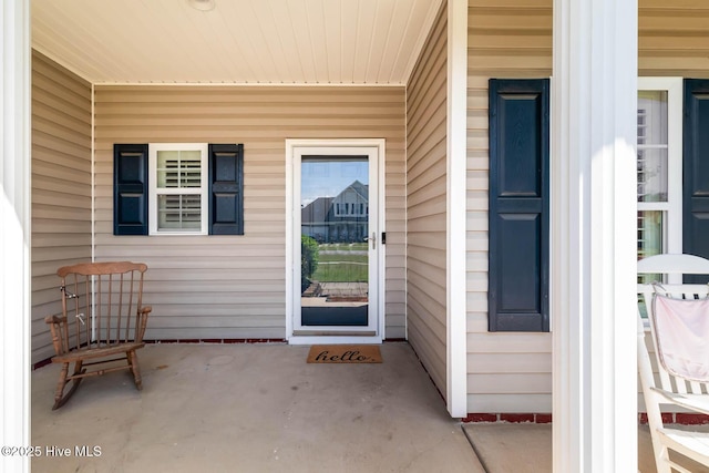 view of exterior entry with covered porch