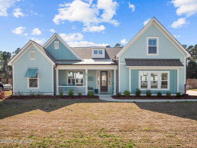 105 Camden Trl, Hampstead, NC 28443 - view of front of home featuring a standing seam roof, covered porch, a front lawn, and metal roof