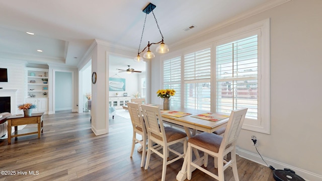 105 Camden Trl, Hampstead, NC 28443 - dining space featuring crown molding, baseboards, wood finished floors, a ceiling fan, and built in shelves