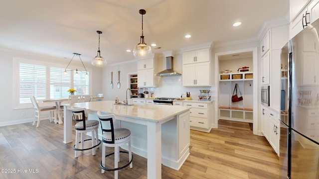 105 Camden Trl, Hampstead, NC 28443 - kitchen featuring wall chimney range hood, stainless steel appliances, ornamental molding, backsplash, and a sink