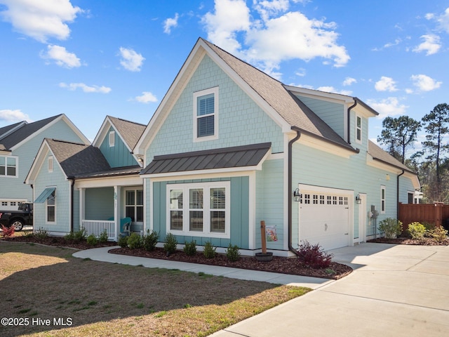 105 Camden Trl, Hampstead, NC 28443 - view of front facade with a porch, driveway, a standing seam roof, and roof with shingles