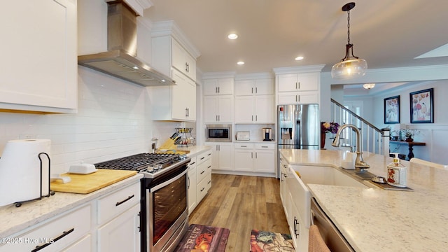 105 Camden Trl, Hampstead, NC 28443 - kitchen featuring wall chimney exhaust hood, stainless steel appliances, backsplash, recessed lighting, and hanging light fixtures
