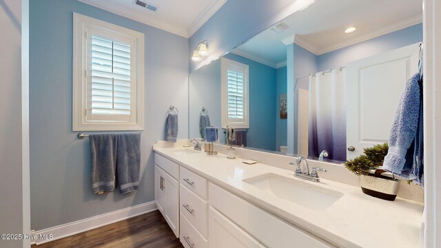 105 Camden Trl, Hampstead, NC 28443 - bathroom with baseboards, double vanity, wood finished floors, crown molding, and toilet