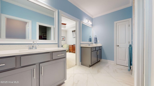 105 Camden Trl, Hampstead, NC 28443 - bathroom with two vanities, crown molding, marble look tiles, and baseboards
