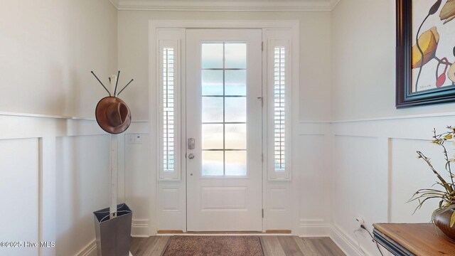 105 Camden Trl, Hampstead, NC 28443 - entryway with wood finished floors, plenty of natural light, crown molding, and a wainscoted wall