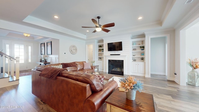 105 Camden Trl, Hampstead, NC 28443 - living room with a raised ceiling, ceiling fan, wood finished floors, stairway, and a fireplace