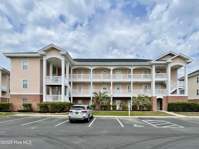 view of building exterior with uncovered parking