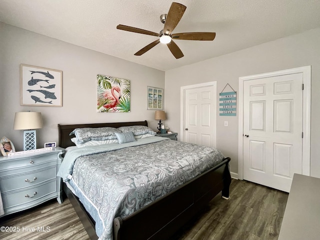 bedroom with a ceiling fan and dark wood-style floors