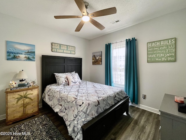bedroom with dark wood-style flooring, baseboards, visible vents, and ceiling fan