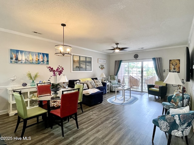 dining space featuring wood finished floors, ceiling fan, a textured ceiling, and visible vents