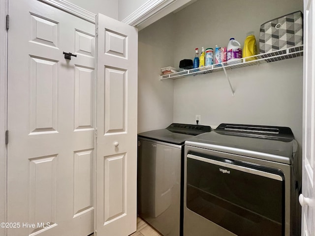 clothes washing area featuring independent washer and dryer and laundry area