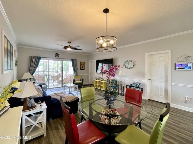dining room with a textured ceiling, ornamental molding, and ceiling fan with notable chandelier