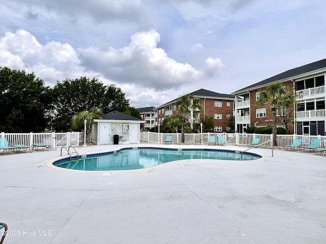 pool featuring a patio and fence