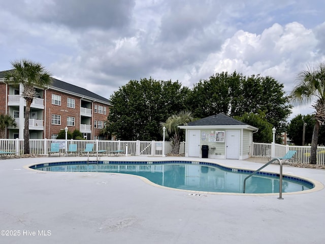 community pool featuring a patio and fence