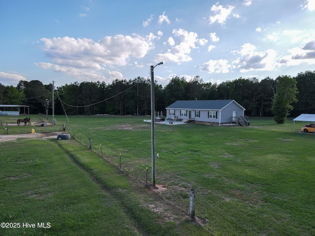 view of yard featuring fence and a view of trees