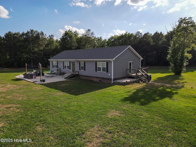 view of front of home with a front yard, a patio, and crawl space