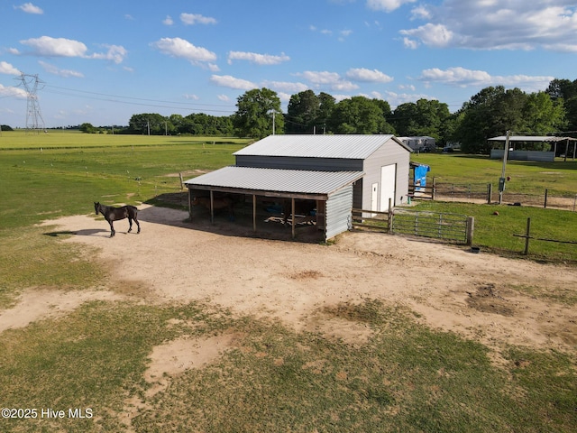 view of horse barn with a rural view