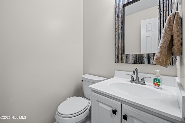half bath with vanity and toilet