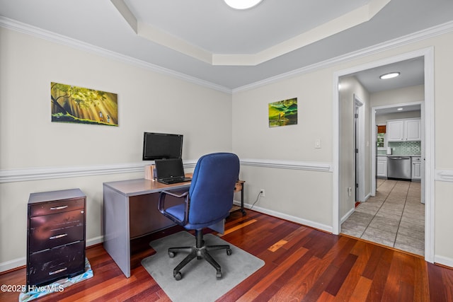 office area with wood finished floors and a tray ceiling