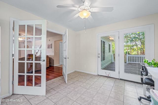 unfurnished room with french doors, light tile patterned floors, a ceiling fan, and baseboards