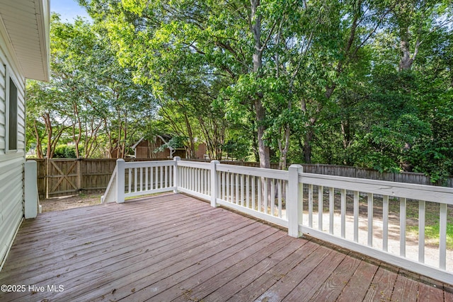 wooden deck with a fenced backyard