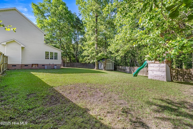 view of yard with central air condition unit, a storage shed, and an outdoor structure