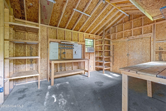 misc room with lofted ceiling, cooling unit, and a workshop area