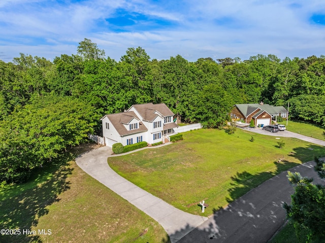 aerial view of property and surrounding area with a forest