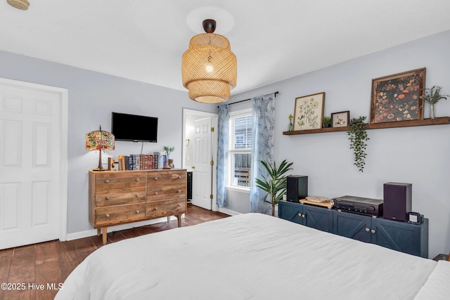 bedroom featuring baseboards and wood finished floors