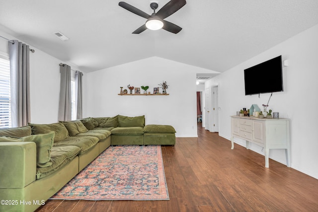 living area with visible vents, ceiling fan, lofted ceiling, and wood finished floors