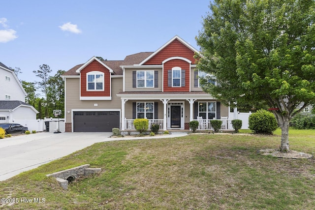craftsman-style home featuring fence, an attached garage, a porch, a front yard, and driveway