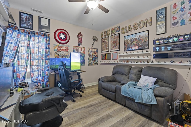 office featuring baseboards, ceiling fan, visible vents, and wood finished floors
