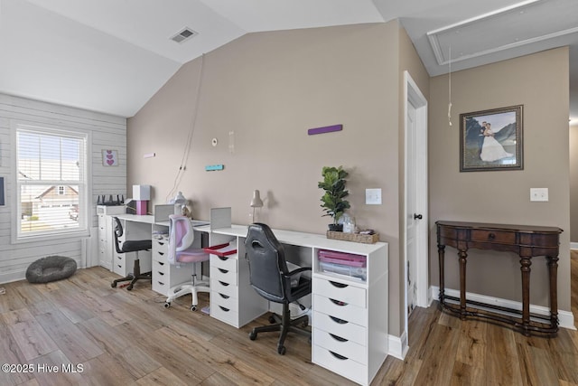 office area with visible vents, attic access, wood finished floors, and lofted ceiling