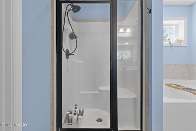 full bath featuring a shower stall and a garden tub