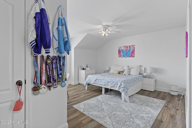 bedroom featuring baseboards, ceiling fan, and wood finished floors