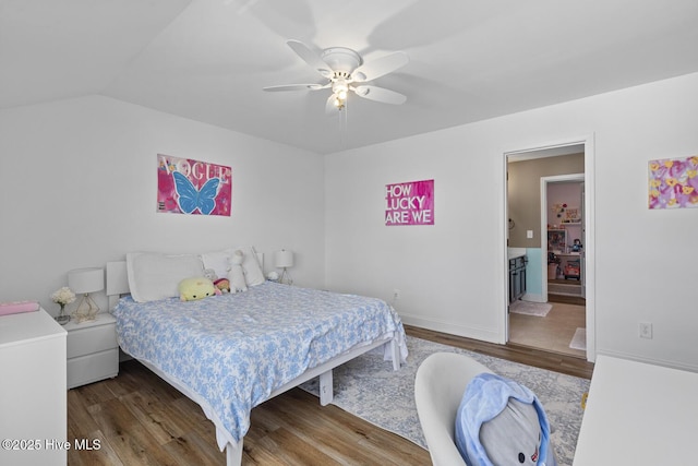 bedroom featuring a ceiling fan, baseboards, wood finished floors, and lofted ceiling