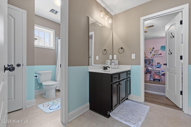 full bathroom featuring vanity, baseboards, toilet, and visible vents