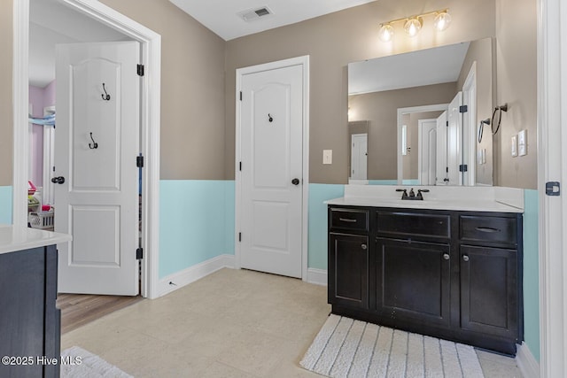 bathroom with visible vents, baseboards, tile patterned floors, and vanity