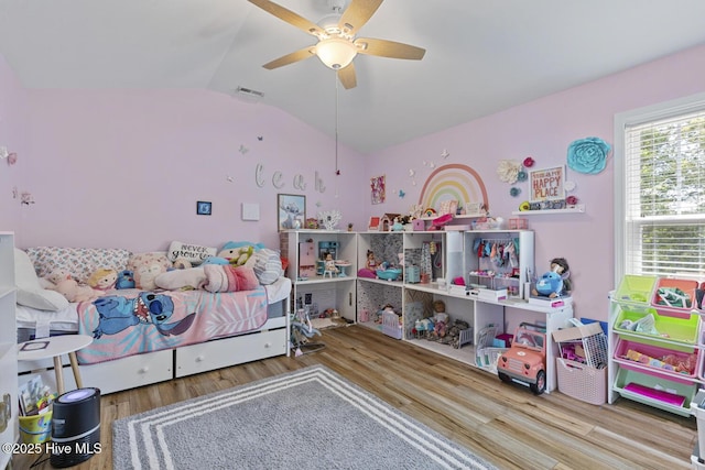 bedroom featuring ceiling fan, lofted ceiling, wood finished floors, and visible vents