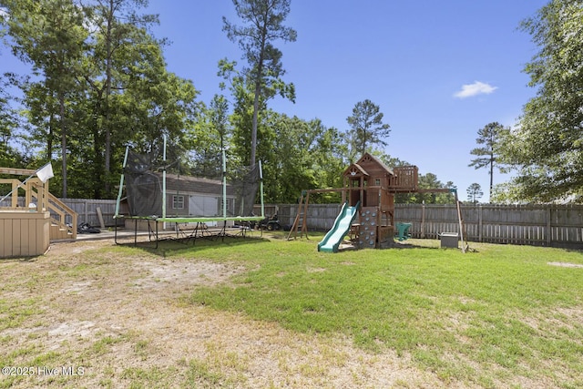 view of yard featuring a playground, a trampoline, and a fenced backyard