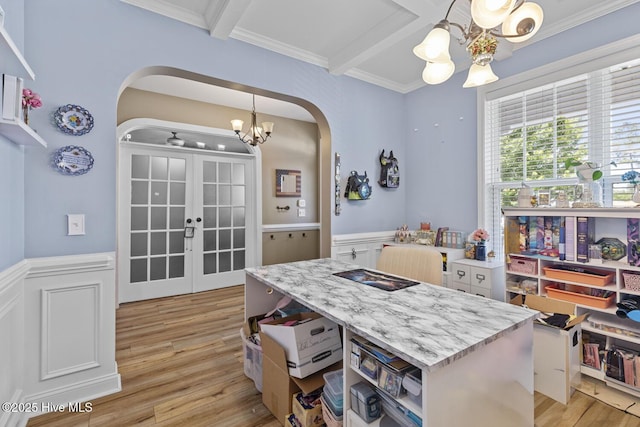 dining area with light wood-style floors, arched walkways, a chandelier, french doors, and beamed ceiling