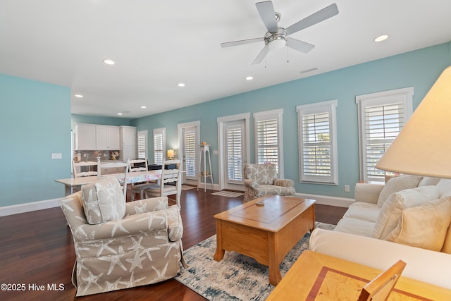 living area featuring baseboards, dark wood-style floors, recessed lighting, and a ceiling fan