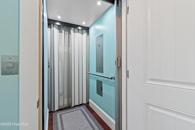 bathroom featuring wood finished floors, elevator, and recessed lighting