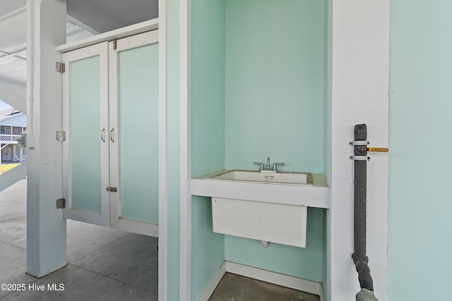bathroom featuring concrete floors and a sink