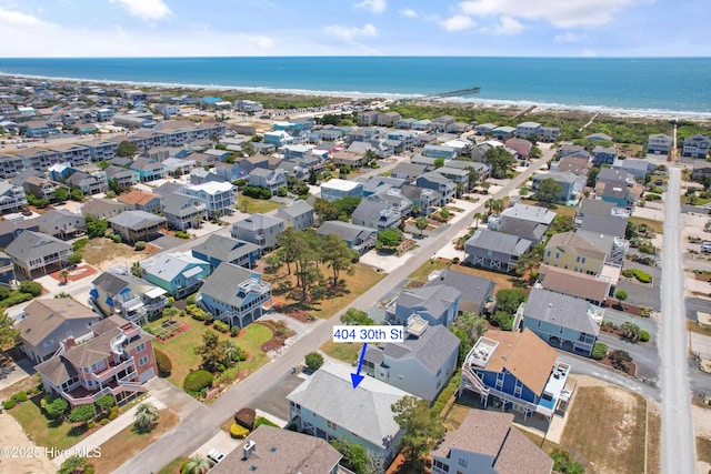 aerial view of residential area featuring a large body of water