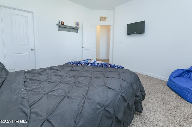 bedroom featuring carpet flooring and baseboards