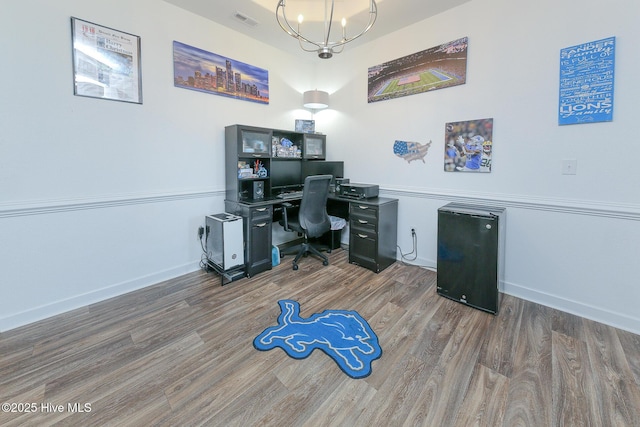office featuring a chandelier, wood finished floors, and baseboards