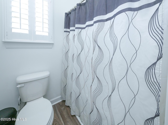 bathroom with toilet and wood finished floors
